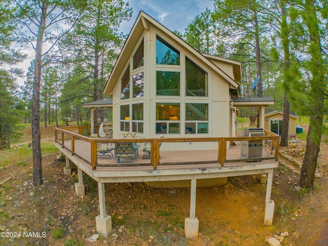 back of property featuring a wooden deck