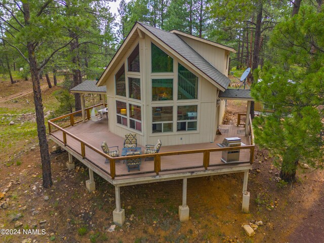 back of property featuring a wooden deck