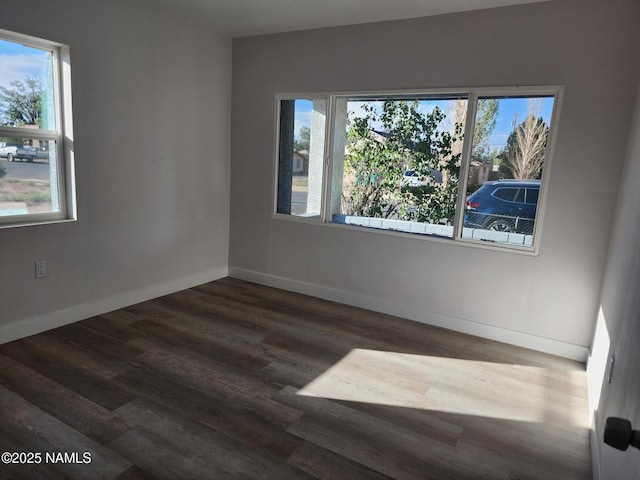 515 W Aspinwall St, Winslow, AZ 86047 - spare room featuring healthy amount of natural light, dark wood-style floors, and baseboards