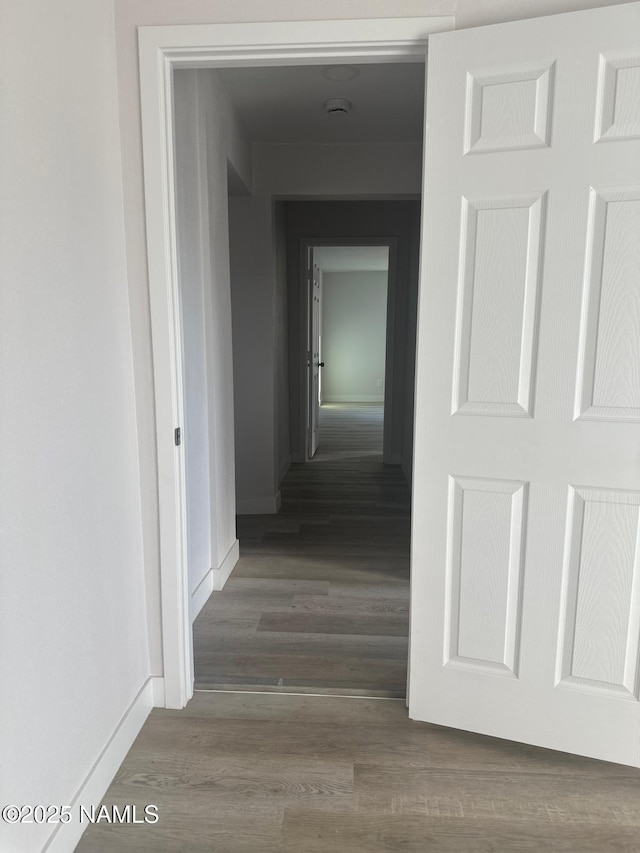 515 W Aspinwall St, Winslow, AZ 86047 - hallway featuring baseboards and wood finished floors
