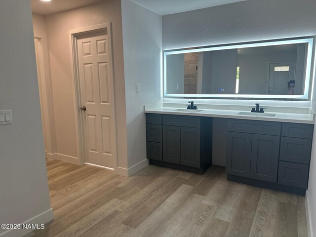 515 W Aspinwall St, Winslow, AZ 86047 - full bath with double vanity, wood finished floors, and baseboards