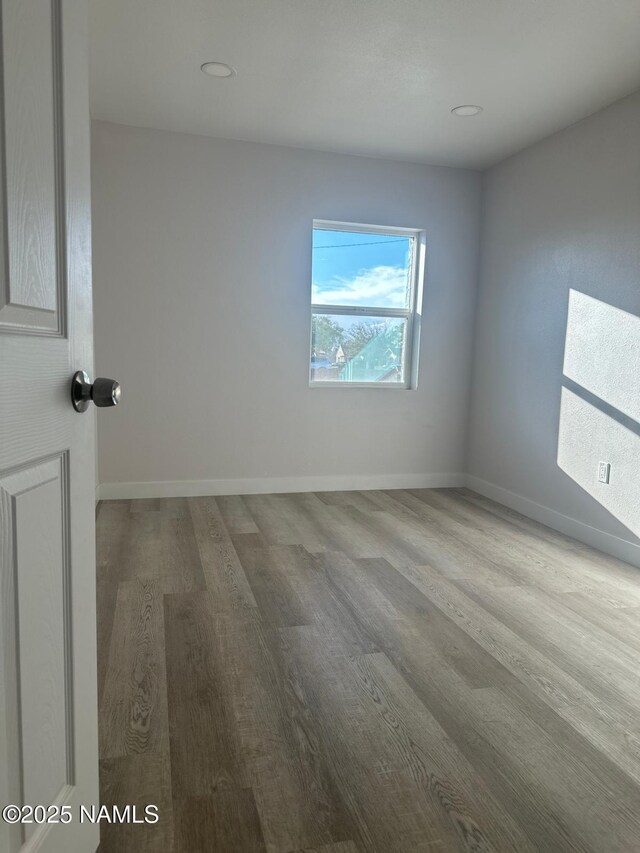 515 W Aspinwall St, Winslow, AZ 86047 - empty room featuring wood finished floors, baseboards, and recessed lighting