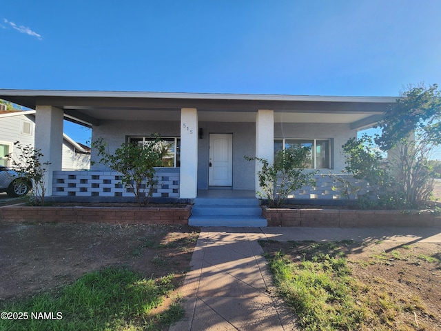 515 W Aspinwall St, Winslow, AZ 86047 - view of front of home with a porch and stucco siding