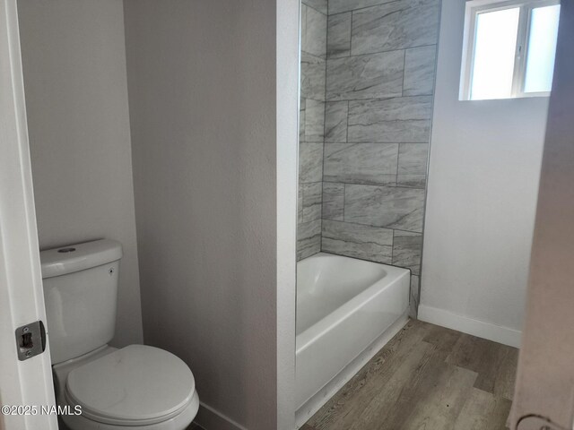 515 W Aspinwall St, Winslow, AZ 86047 - bathroom featuring wood finished floors, toilet, and baseboards