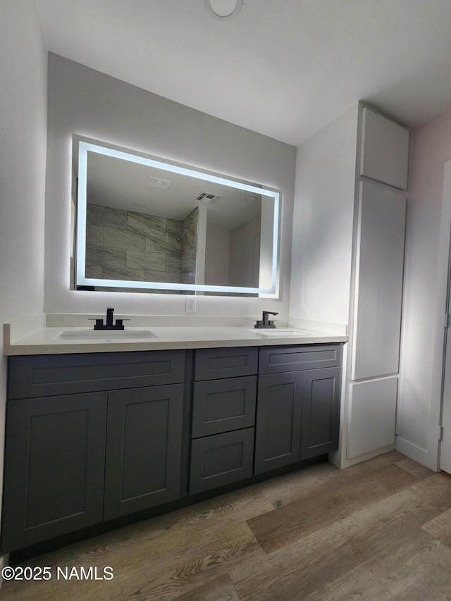 515 W Aspinwall St, Winslow, AZ 86047 - bathroom with double vanity and wood finished floors