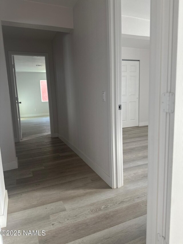 515 W Aspinwall St, Winslow, AZ 86047 - hall with wood finished floors and baseboards