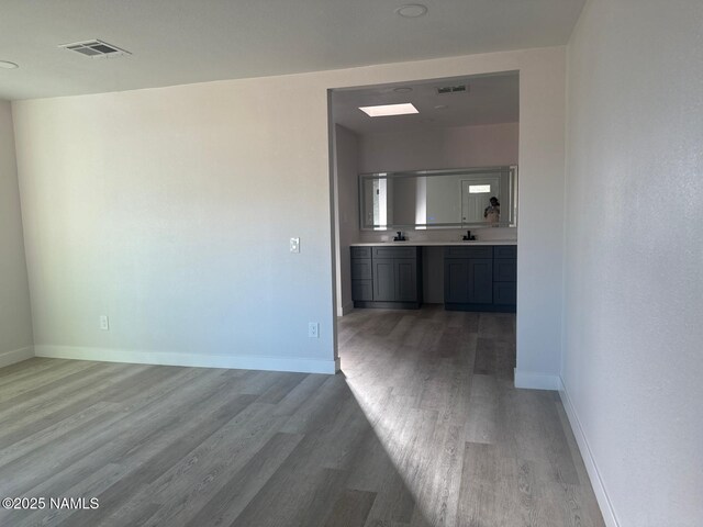 515 W Aspinwall St, Winslow, AZ 86047 - unfurnished living room featuring wood finished floors and baseboards