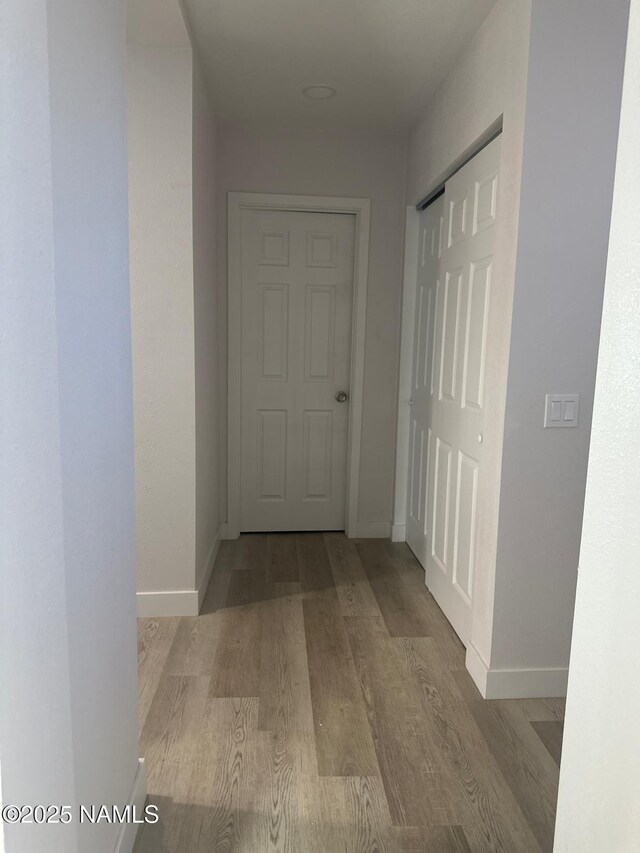 515 W Aspinwall St, Winslow, AZ 86047 - hallway with wood finished floors and baseboards