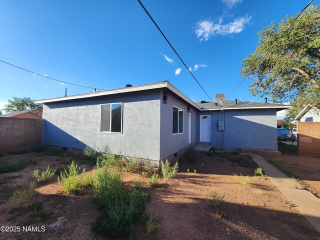 515 W Aspinwall St, Winslow, AZ 86047 - back of house with crawl space and stucco siding