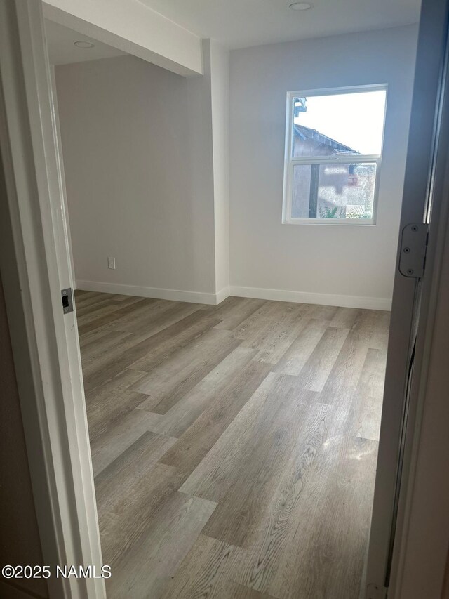 515 W Aspinwall St, Winslow, AZ 86047 - spare room featuring wood finished floors and baseboards