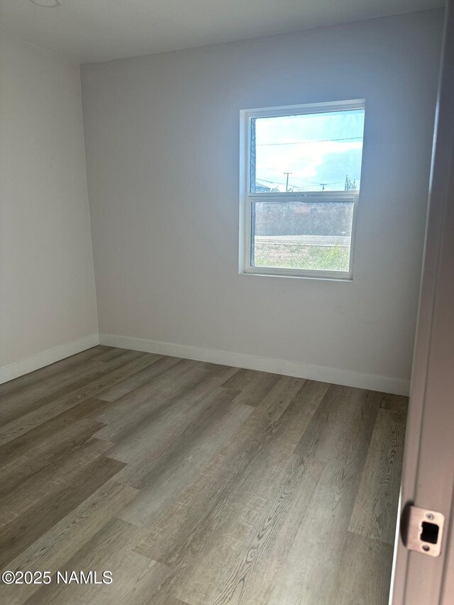515 W Aspinwall St, Winslow, AZ 86047 - unfurnished room featuring wood finished floors and baseboards