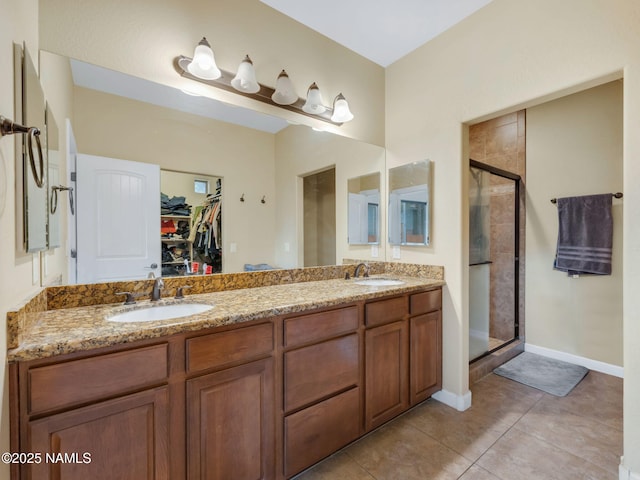 449 E Woodland Dr, Flagstaff, AZ 86001 - bathroom with a walk in closet, tile patterned floors, a stall shower, and a sink