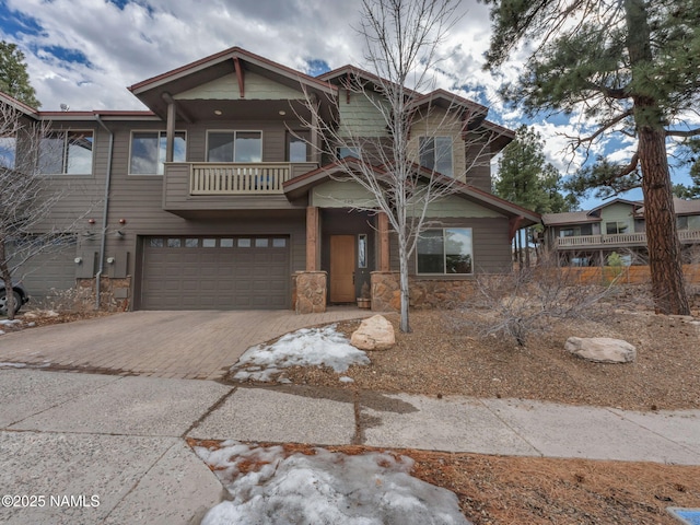 449 E Woodland Dr, Flagstaff, AZ 86001 - craftsman-style house with decorative driveway, a garage, and stone siding