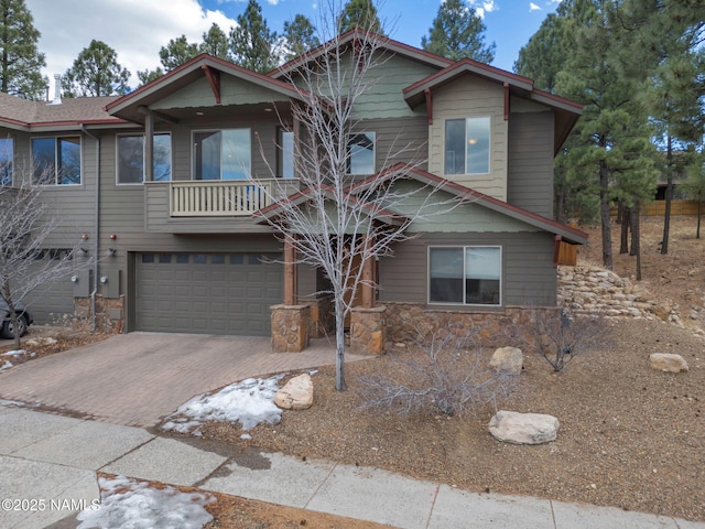 449 E Woodland Dr, Flagstaff, AZ 86001 - view of front of house with decorative driveway, stone siding, and a garage