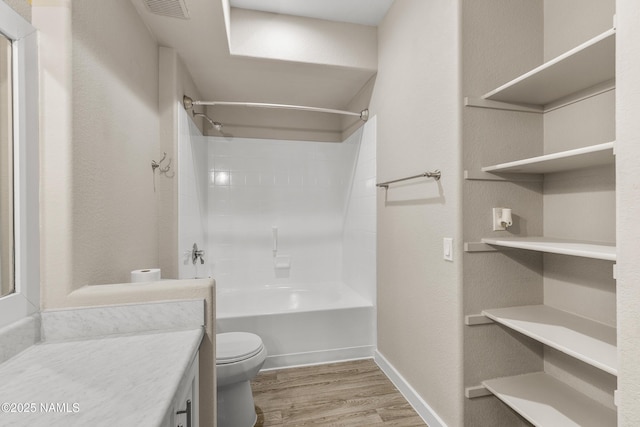 full bathroom featuring vanity, toilet, bathing tub / shower combination, and wood-type flooring