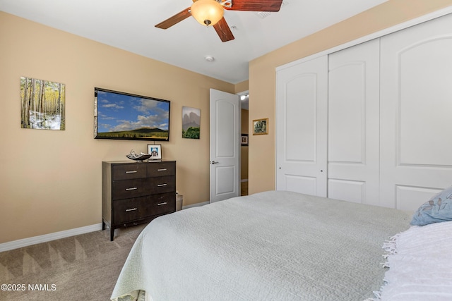 bedroom with a ceiling fan, baseboards, a closet, and carpet