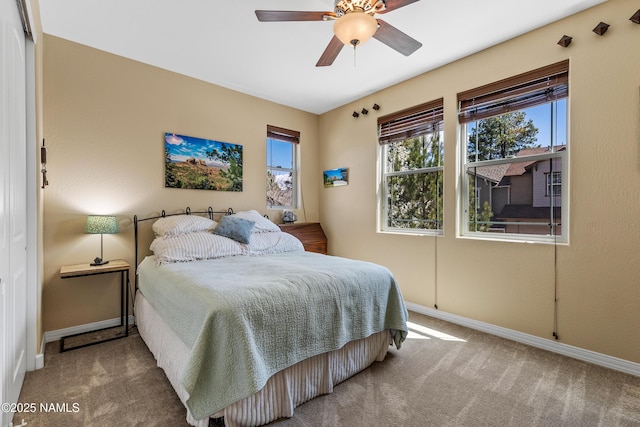 bedroom with baseboards, a ceiling fan, and carpet