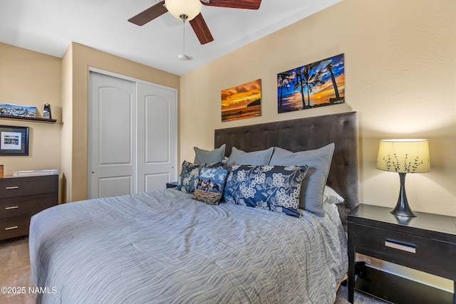 carpeted bedroom featuring a ceiling fan and a closet