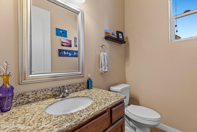 bathroom featuring toilet and vanity