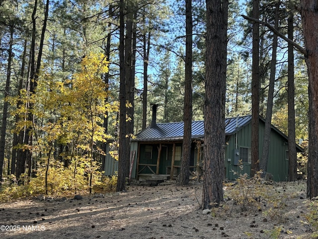 view of front of home featuring metal roof, board and batten siding, covered porch, and a standing seam roof