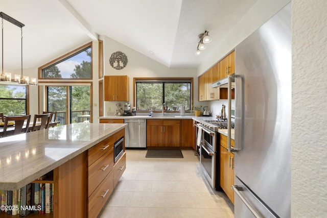 2169 E Skyline Dr, Flagstaff, AZ 86004 - kitchen with appliances with stainless steel finishes, brown cabinetry, light tile patterned floors, under cabinet range hood, and light stone countertops