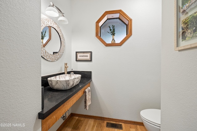 2169 E Skyline Dr, Flagstaff, AZ 86004 - half bathroom with wood finished floors and vanity