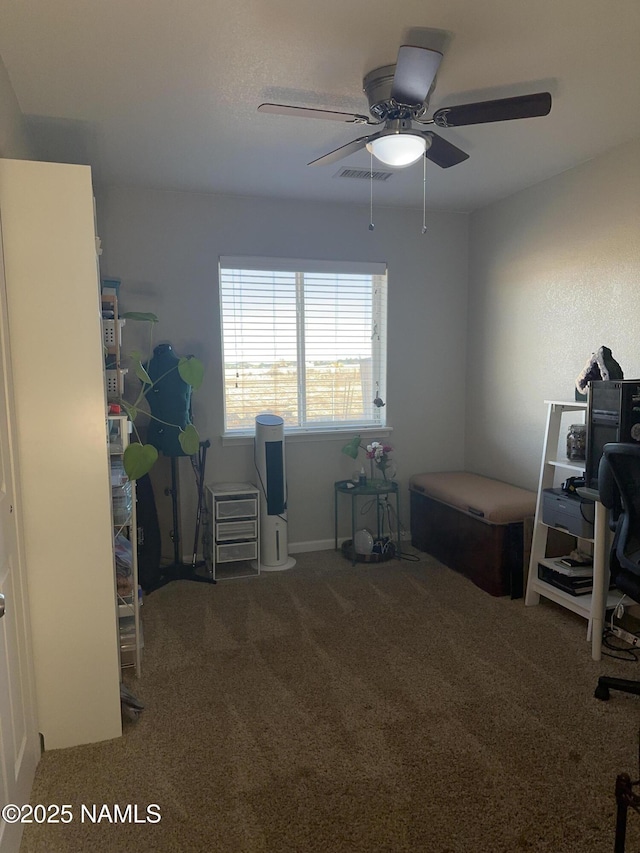 carpeted office with visible vents and a ceiling fan
