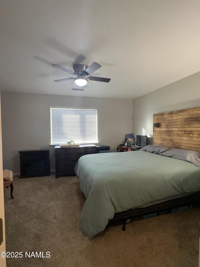 carpeted bedroom featuring ceiling fan and visible vents