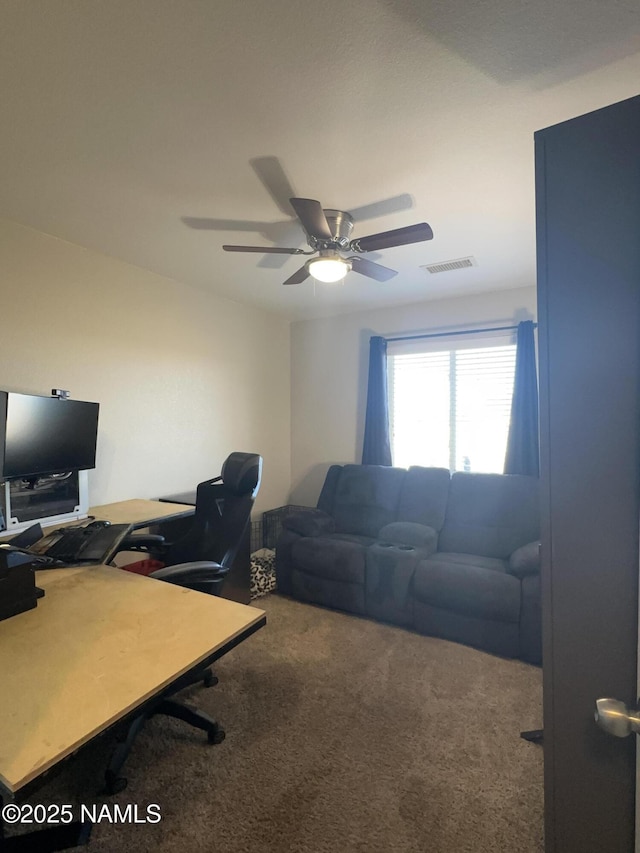 carpeted home office featuring ceiling fan and visible vents