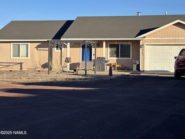 ranch-style home featuring a garage