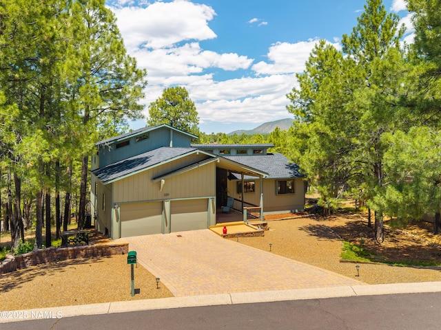2201 N Rio De Flag Dr, Flagstaff, AZ 86004 - view of front of home with roof with shingles, decorative driveway, and a mountain view