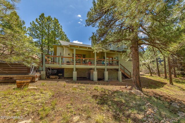 2201 N Rio De Flag Dr, Flagstaff, AZ 86004 - back of property featuring board and batten siding, stairs, and a wooden deck