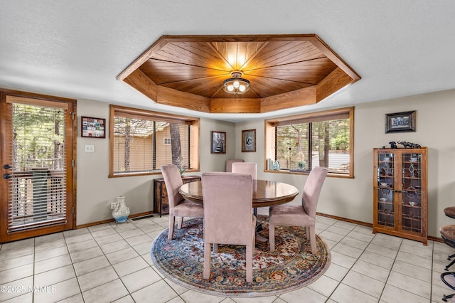 2201 N Rio De Flag Dr, Flagstaff, AZ 86004 - dining area featuring a raised ceiling, light tile patterned flooring, and a textured ceiling