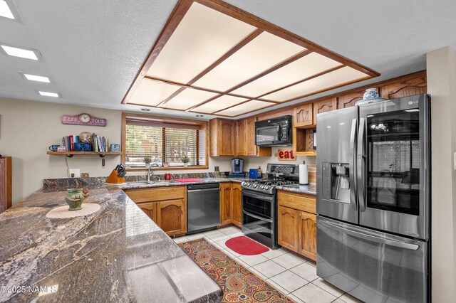 2201 N Rio De Flag Dr, Flagstaff, AZ 86004 - kitchen with appliances with stainless steel finishes, brown cabinetry, open shelves, light tile patterned floors, and a textured ceiling