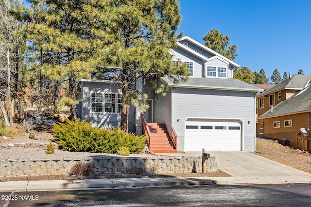 traditional-style home with concrete driveway, an attached garage, and stairs