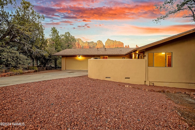 property exterior at dusk featuring a garage