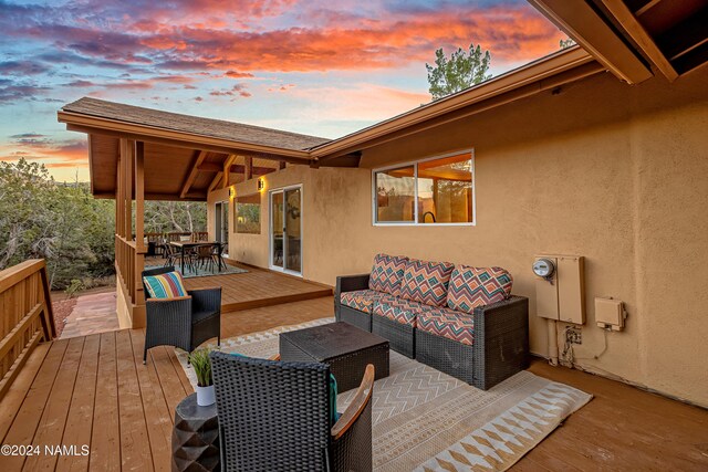 deck at dusk with an outdoor hangout area