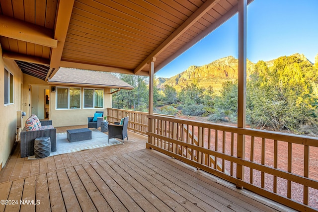 deck with a mountain view and outdoor lounge area