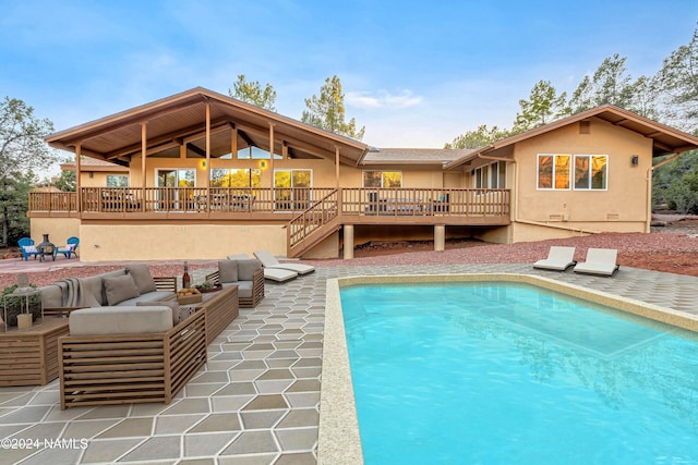 view of swimming pool with a patio area, a wooden deck, and an outdoor hangout area