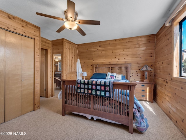 7284 N Buck Ridge Rd, Williams, AZ 86046 - carpeted bedroom featuring wood walls, a closet, and a ceiling fan