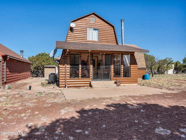 7284 N Buck Ridge Rd, Williams, AZ 86046 - back of property with a gambrel roof, entry steps, roof with shingles, and a sunroom