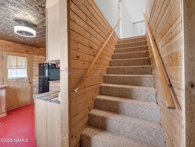 7284 N Buck Ridge Rd, Williams, AZ 86046 - stairs featuring carpet floors, an ornate ceiling, and wood walls
