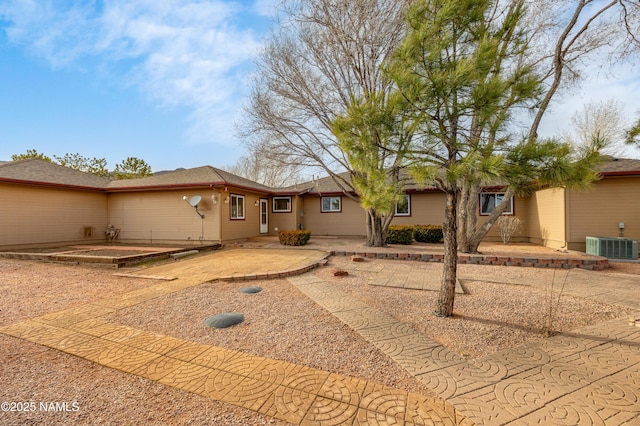 view of front of property featuring a patio area and central air condition unit