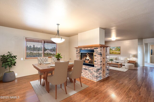 kitchen with a kitchen island, a sink, light countertops, backsplash, and black appliances