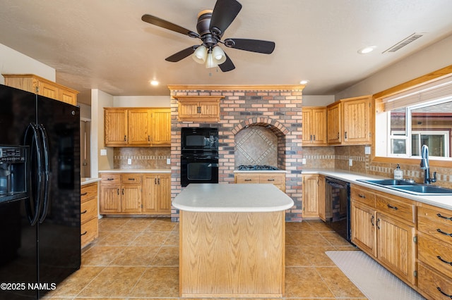 kitchen featuring black appliances, decorative backsplash, light countertops, and a sink