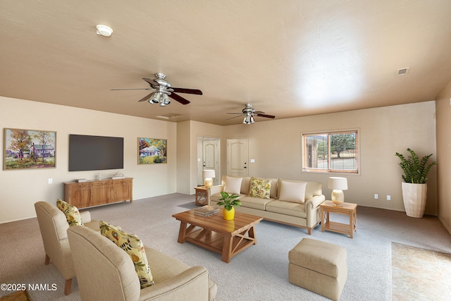 living room featuring ceiling fan and light colored carpet