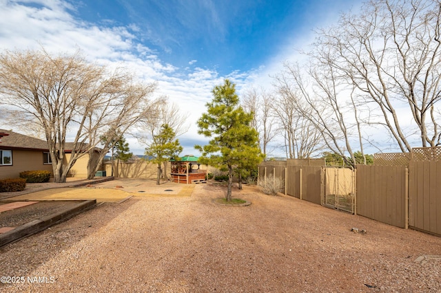 view of yard with fence and a gate