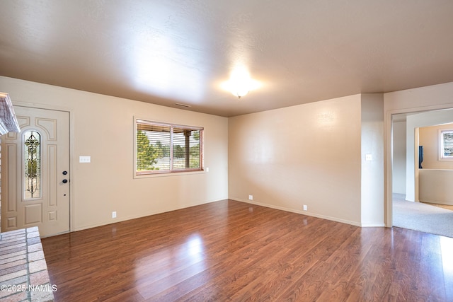 interior space featuring visible vents, baseboards, and wood finished floors