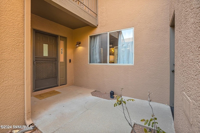 property entrance featuring a patio area