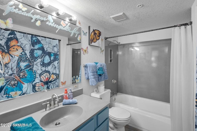 full bathroom featuring toilet, a textured ceiling, shower / tub combo, and vanity